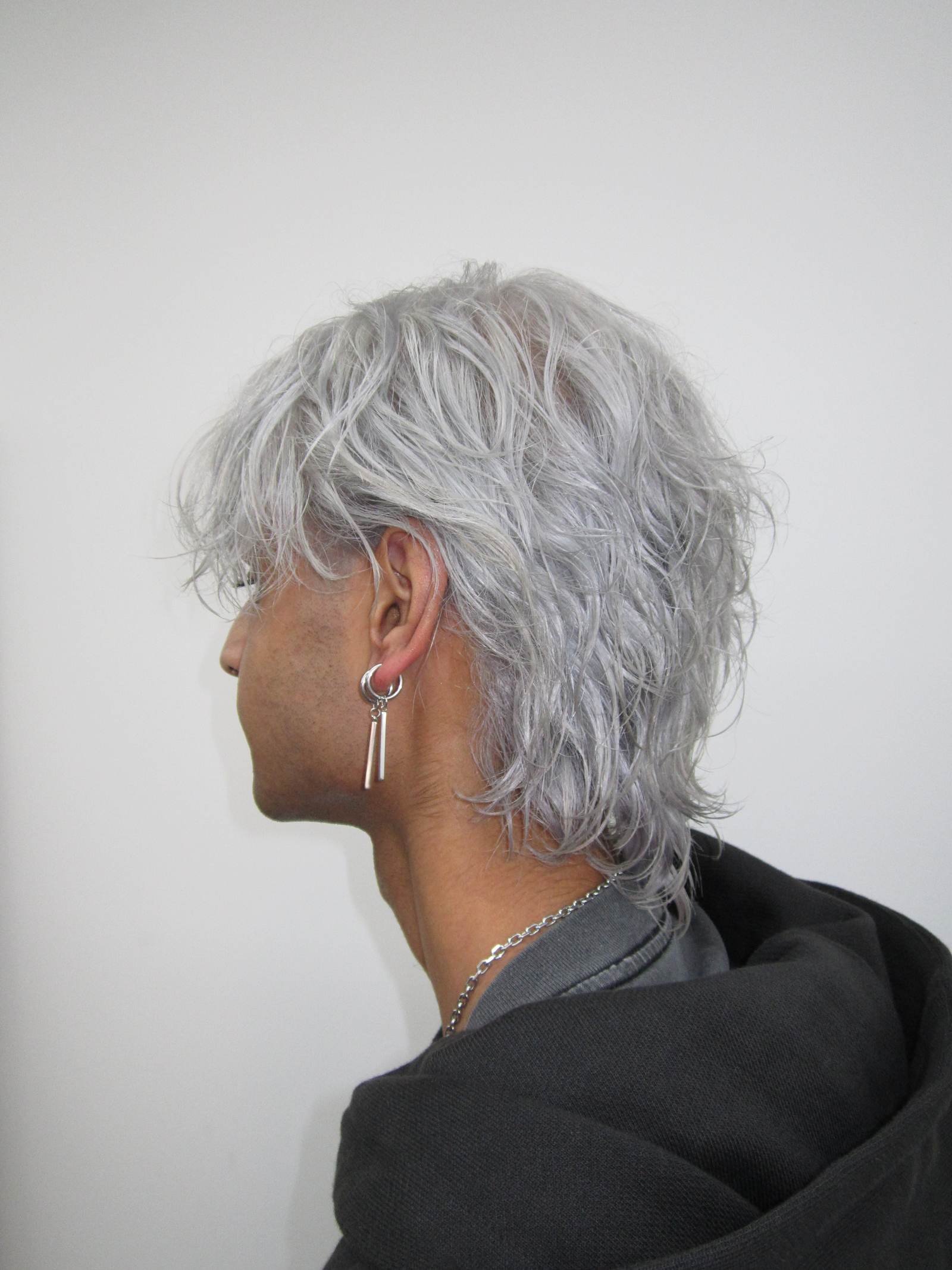 Men's icy white platinum hair transformation with layered styling and K18 treatment at Assort Melbourne