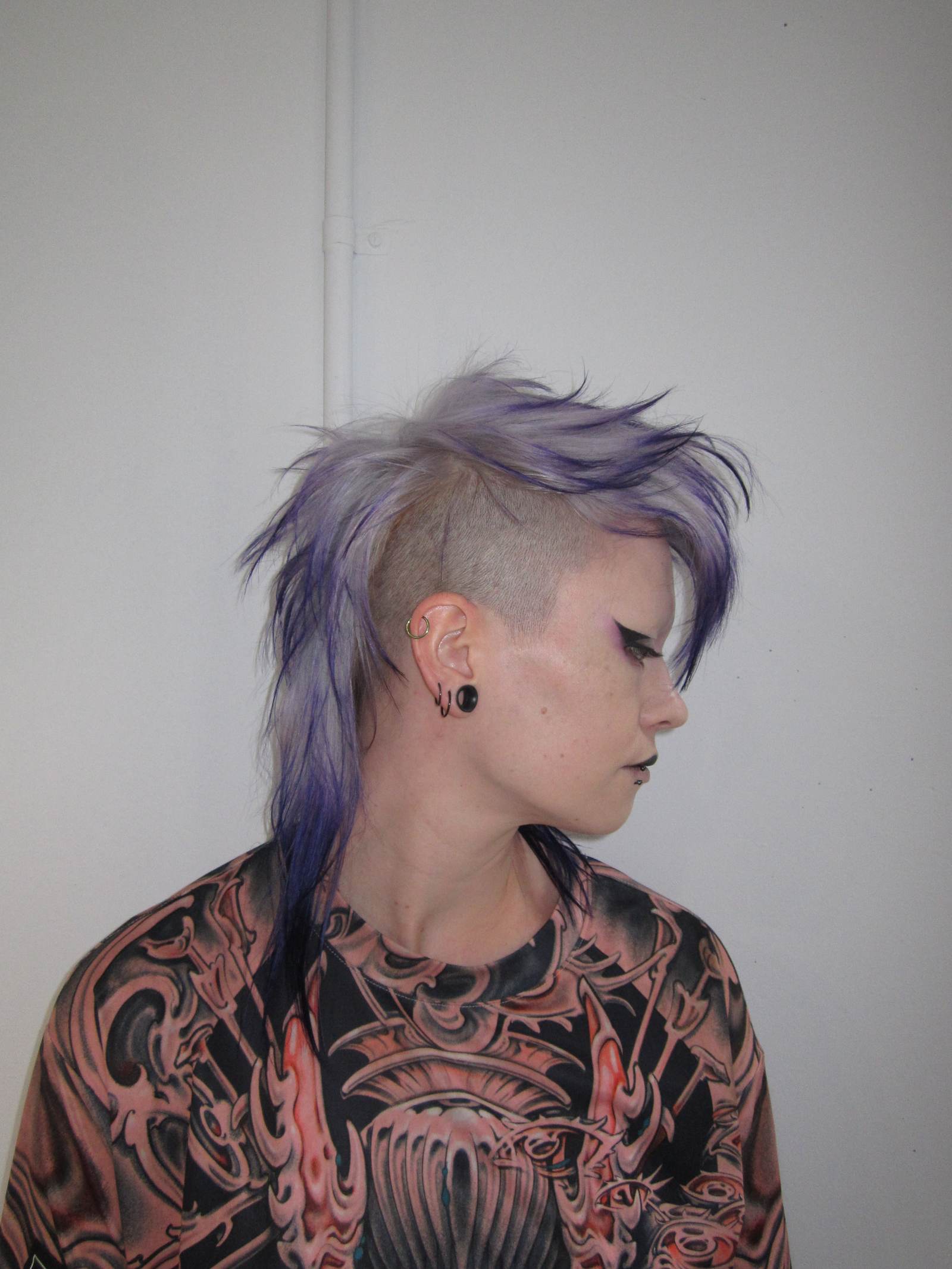 High-texture mohawk featuring a seamless color melt from a light lavender base to deep, rich purple tips, styled at Assort Melbourne.