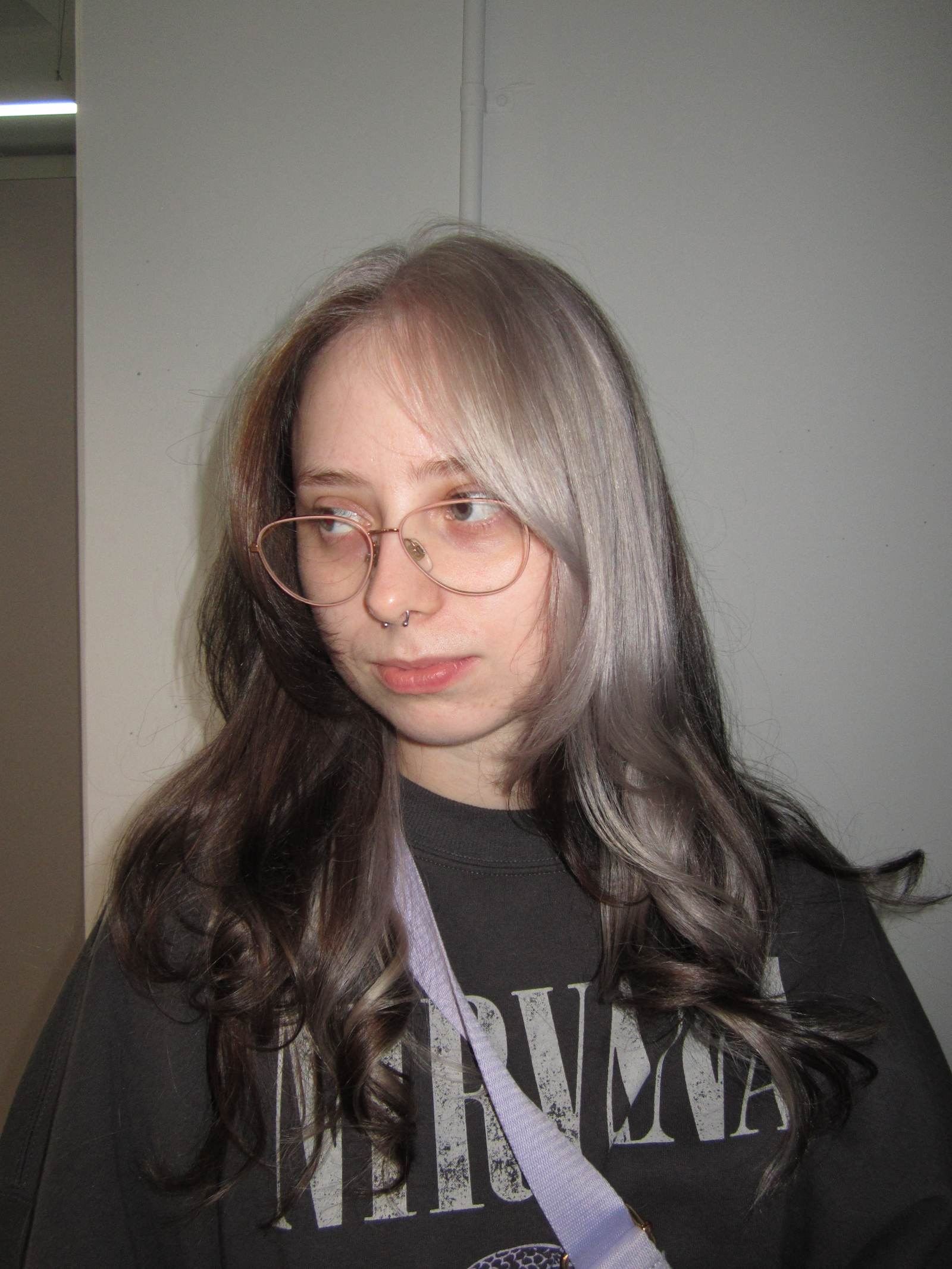 A stunning creative colour block hair transformation at Assort Melbourne, featuring a high-contrast silver section against natural dark hair with a glossy K18 finish.