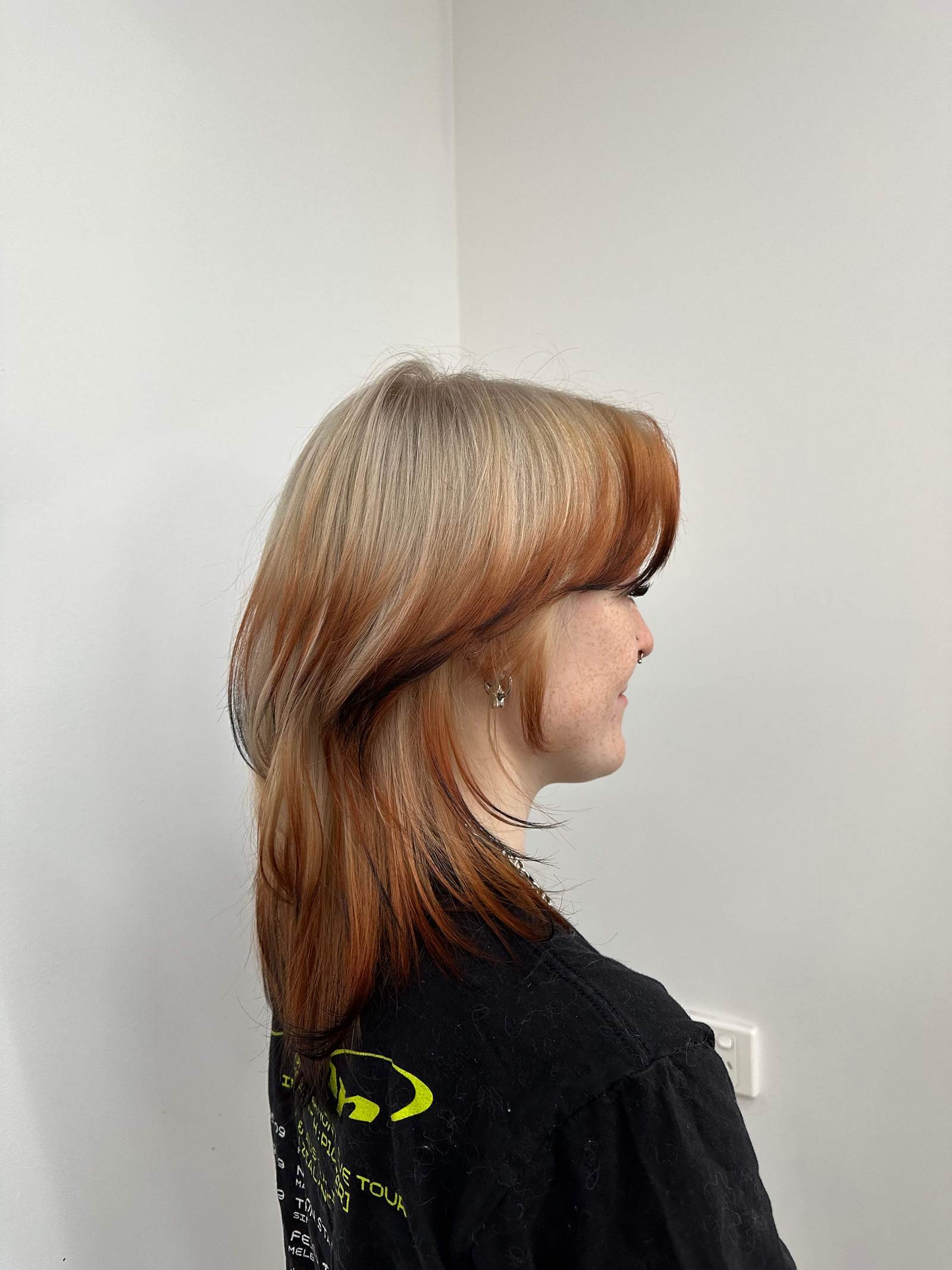 A striking 'Fox Tail' hair design at Assort Melbourne, featuring a bright ginger-blonde base with sharply contrasted deep mahogany ends to mimic a natural fox tail gradient.