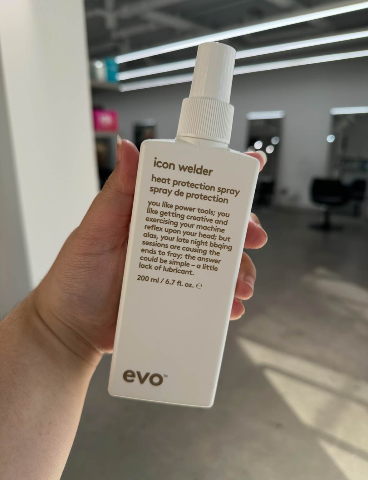 A bottle of EVO Icon Wielder, a premium heat protectant used at Assort Melbourne