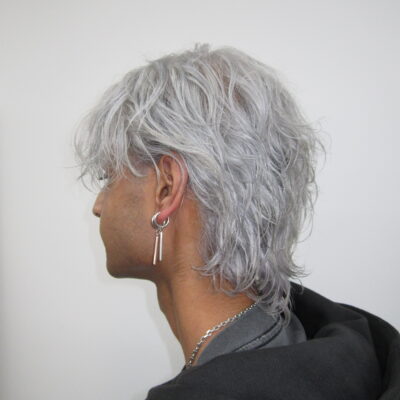 Men's icy white platinum hair transformation with layered styling and K18 treatment at Assort Melbourne