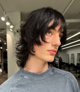 A close-up of soft, textured curtain bangs styled on a client at Assort Melbourne hair salon in Collingwood, showcasing a modern face-framing fringe