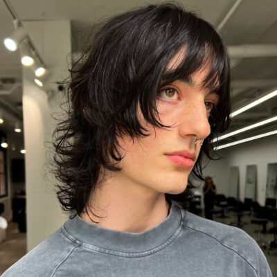 A close-up of soft, textured curtain bangs styled on a client at Assort Melbourne hair salon in Collingwood, showcasing a modern face-framing fringe