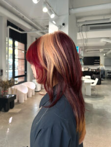 A client at Assort Melbourne with bold red, blonde and burgundy color blocking.