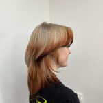 A striking 'Fox Tail' hair design at Assort Melbourne, featuring a bright ginger-blonde base with sharply contrasted deep mahogany ends to mimic a natural fox tail gradient.