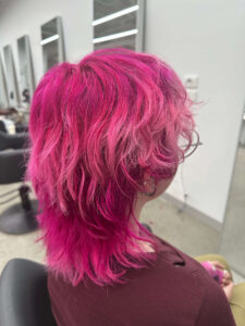 A shaggy layered Hot Pink Hair transformation with a light Pink mid section done at Assort Melbourne