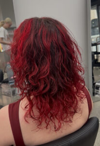 Close-up of bouncy, defined curls with high shine, styled at Assort Melbourne using EVO Liquid Rollers.