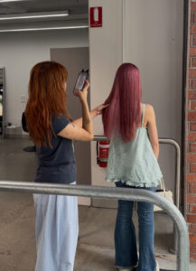 An Assort Melbourne Stylist taking a picture of their clients new Cool toned Pink hair