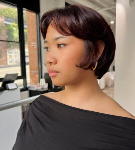 A client at Assort Melbourne featuring a textured Bixie haircut with soft, face-framing layers