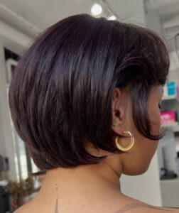 Stylist at Assort Melbourne finishing an Air Bob with a high-shine blowout.