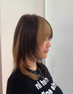 A client at Assort Melbourne with bold black and warm blonde color blocking.