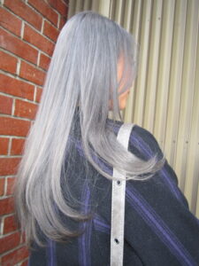 after hair transformation at Assort Melbourne showing outgrown bleach shifted to an even, high-shine grey double process.
