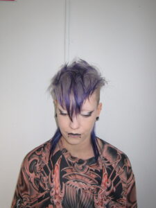 High-texture mohawk featuring a seamless color melt from a light lavender base to deep, rich purple tips, styled at Assort Melbourne.