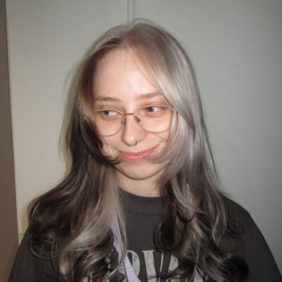 A stunning creative colour block hair transformation at Assort Melbourne, featuring a high-contrast silver section against natural dark hair with a glossy K18 finish.