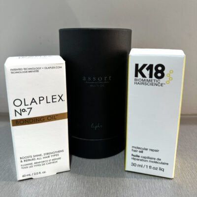 Product line up of Olaplex, Assort Brand and K18 Hair oils on a shelf at Assort Melbourne