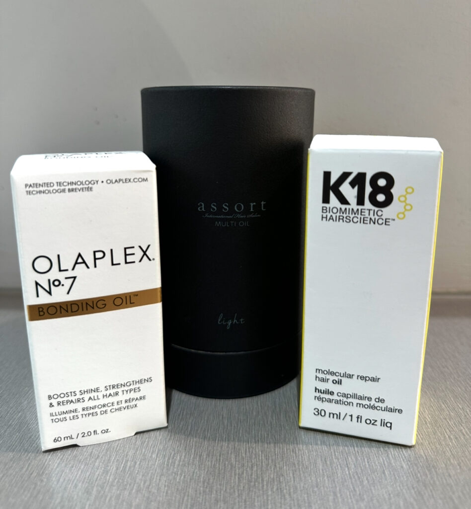 Product line up of Olaplex, Assort Brand and K18 Hair oils on a shelf at Assort Melbourne 